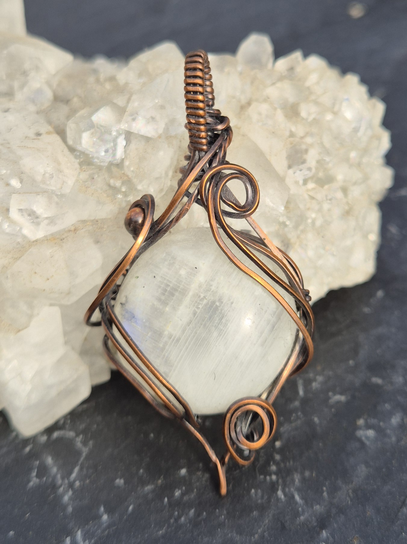 Moonstone Pendant photographed with mineral crystals