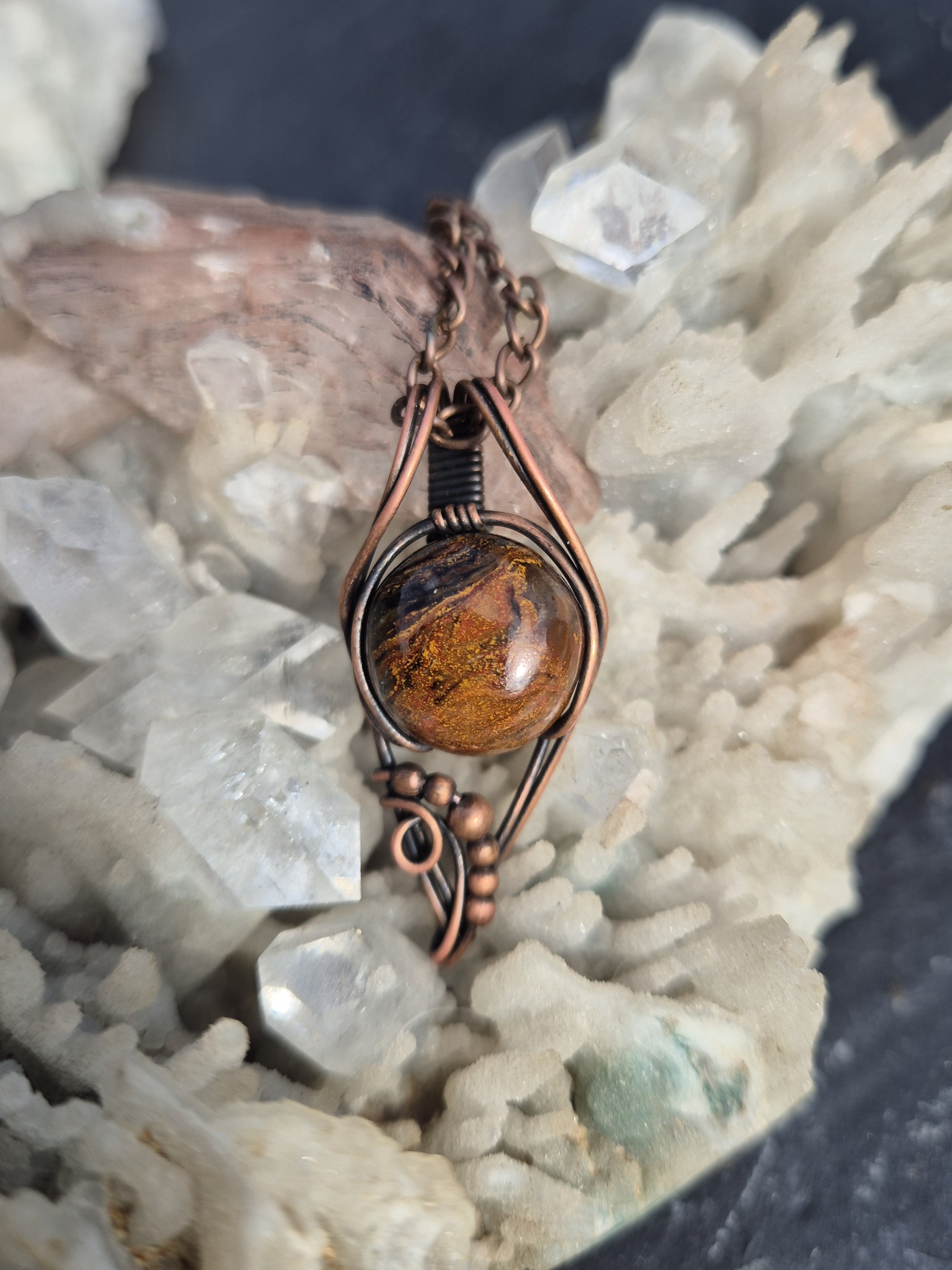 Pietersite Pendant photographed with mineral crystals